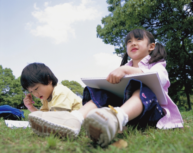 イラスト＆写真のストックフォトwaha（ワーハ）　人物、日本人、子供、小学生、男の子、女の子、2人、屋外、公園、絵を描く、スケッチ、スケッチブック、ローアングル、アート、絵、描く、お絵かき、落書き　p3-0855b