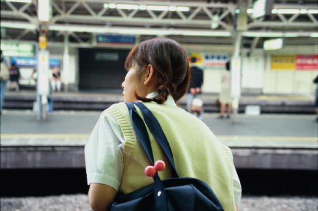 イラスト＆写真のストックフォトwaha（ワーハ）　人物、日本人、高校生、学生、屋外、後ろ姿、後姿、背中、上半身、逆光、待つ、駅、ステーション、電車通学、覗く、後姿、後ろ姿、うしろ姿、背中、女子高生　p5-0600bv